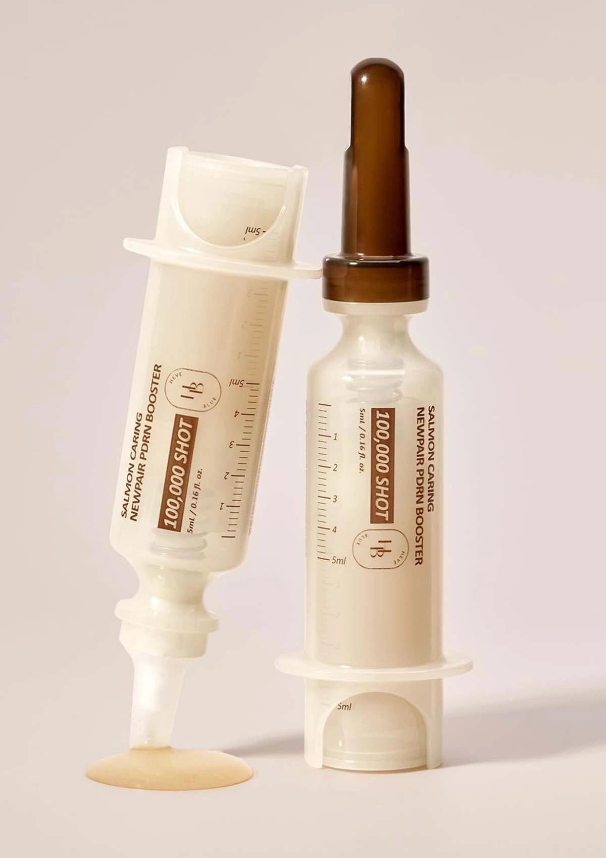 Skincare product with dropper and applicator on a light background